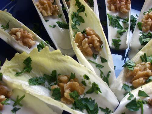 Endives served with walnuts and parsely on the top